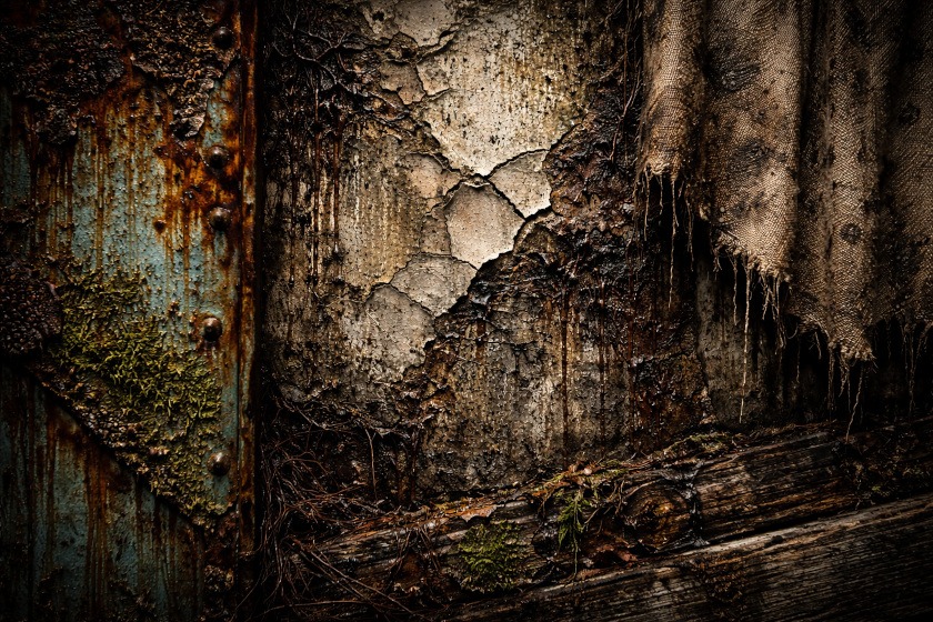 Close-up of cracked concrete, rusted metal, peeling paint, and stained fabric textures used as real-world reference for horror art.