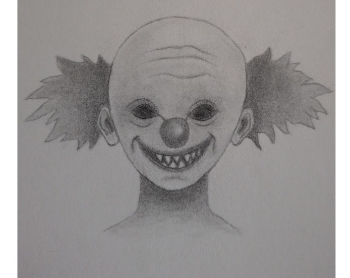 Finished scary clown pencil drawing with dark eyes, sharp teeth, and shaded hair tutorial image.